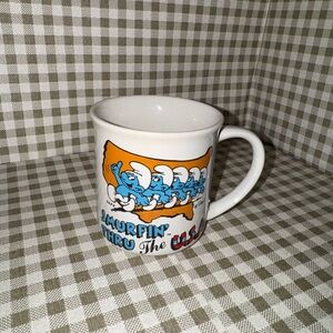Source Unknown White Mug with Blue Smurf Characters and Orange USA Graphic